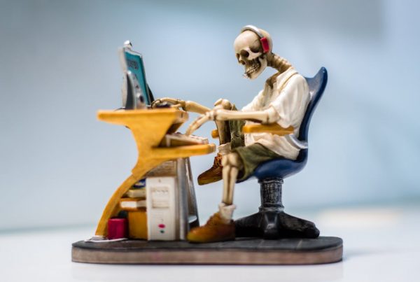 Skeleton on a chair fighting review spam in his financial marketing!